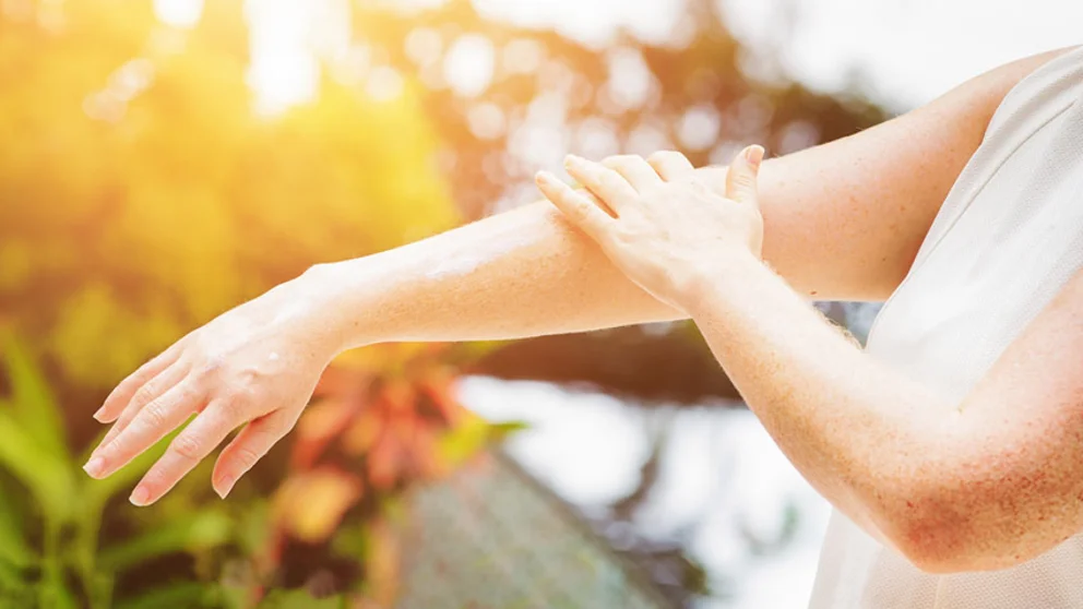 Woman applying sunblock