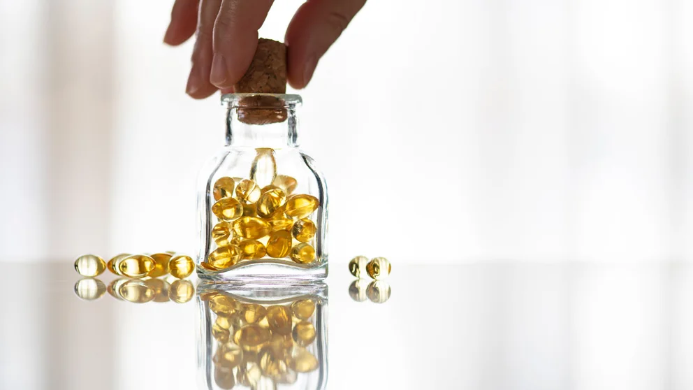 person closing bottle of vitamins