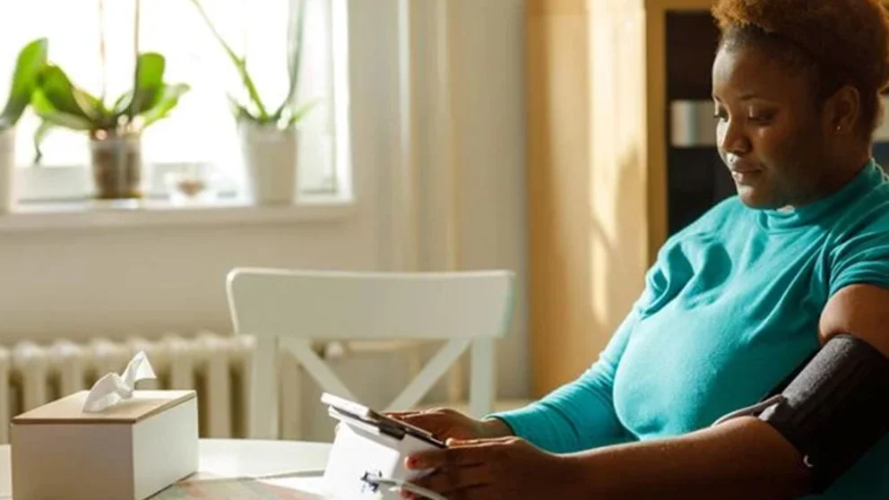 A woman checking her blood pressure.