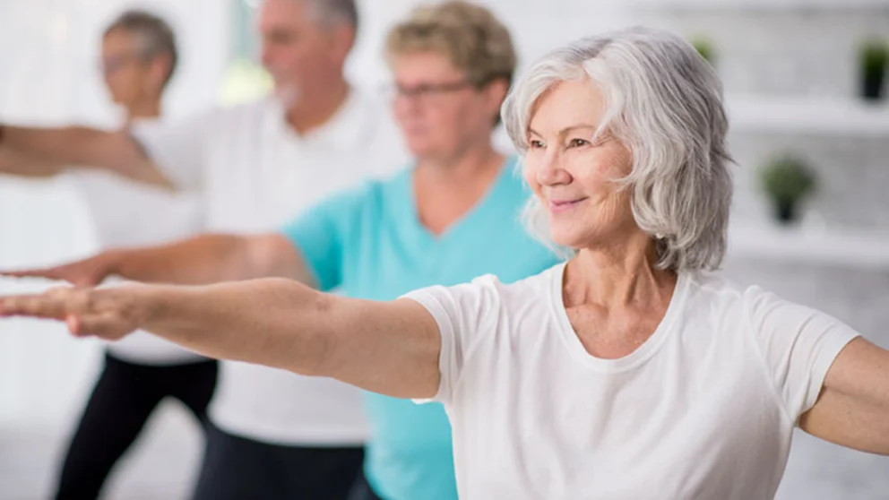 Four people doing stretching exercises.