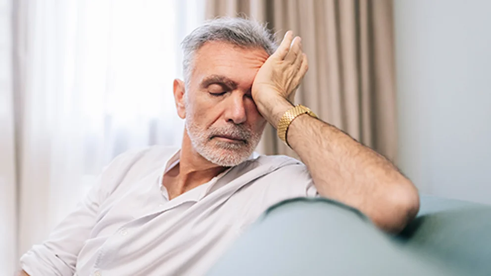 Older man suffering from fatigue. Fatigue isn't a normal part of aging and can be caused by medications.