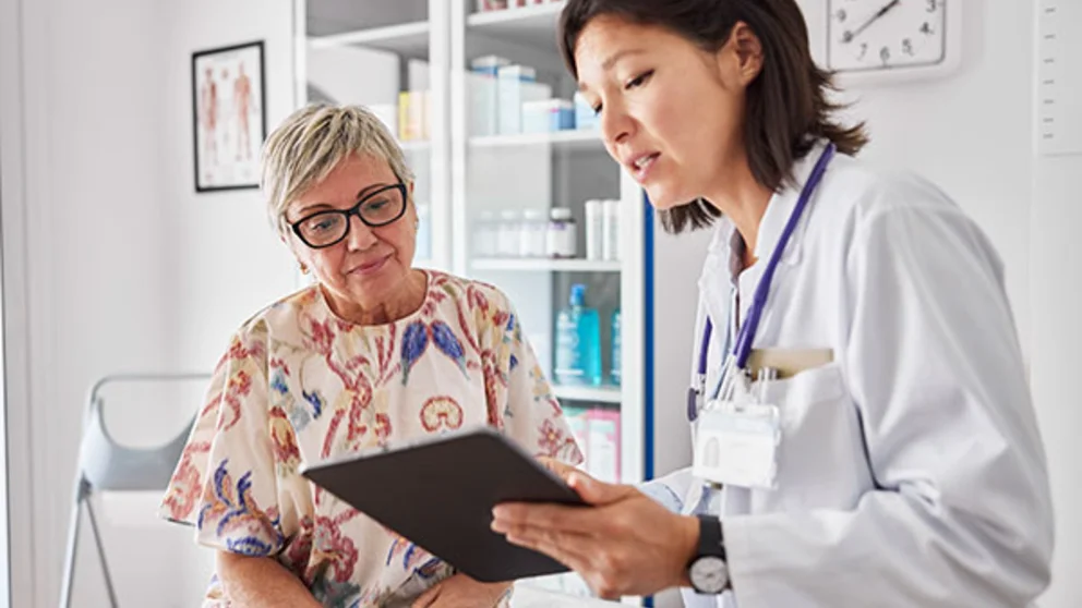 A woman goes over results with her doctor