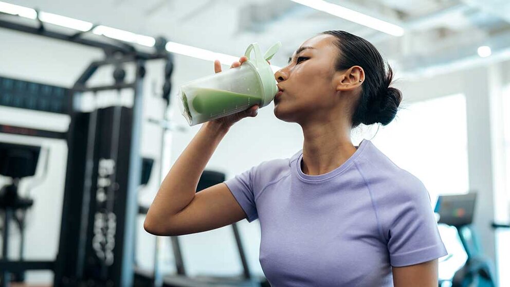 Woman drinking protein shake after workout.