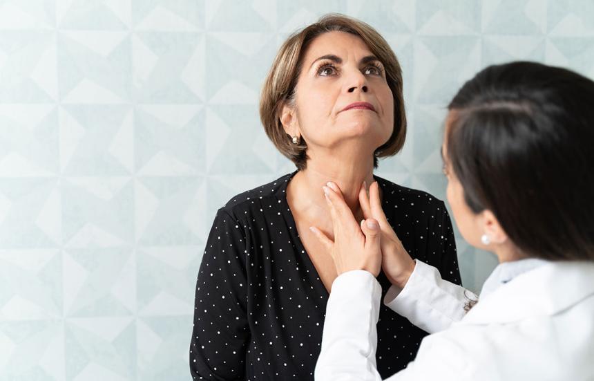 Doctor checking patient's thyroid