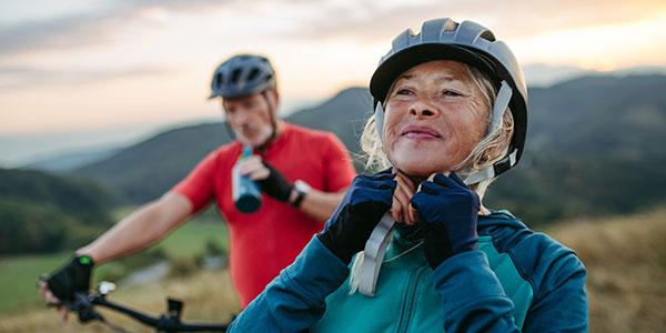Woman and man mountain biking.