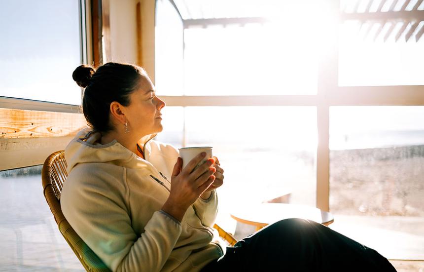 Woman relaxing while drinking a cup of green tea