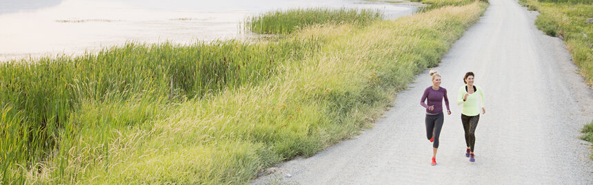 Women jogging on rural road