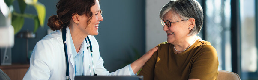 Doctor speaking with a patient during an office visit.