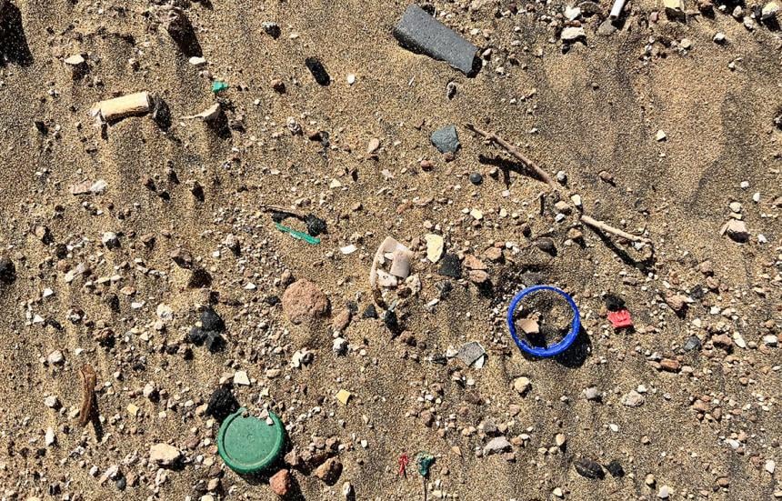 Beach sand with visible plastic debris
