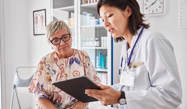 A woman goes over results with her doctor