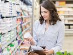 Woman shopping for yogurt with live probiotic cultures