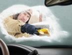 Man scraping down icy windshield