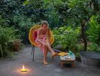 Woman sitting outside with citronella and insect repellent