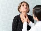 Doctor checking patient's thyroid
