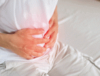 Man holding his stomach in pain