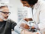 A doctor takes a patient's blood pressure