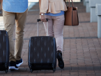 Senior Couple Walking Through Public Transport Station