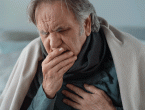elderly person coughing into hand