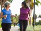 two middle aged women walking and holding water bottles