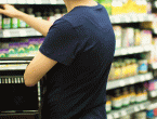 grocery shopper picking up supplement from shelves
