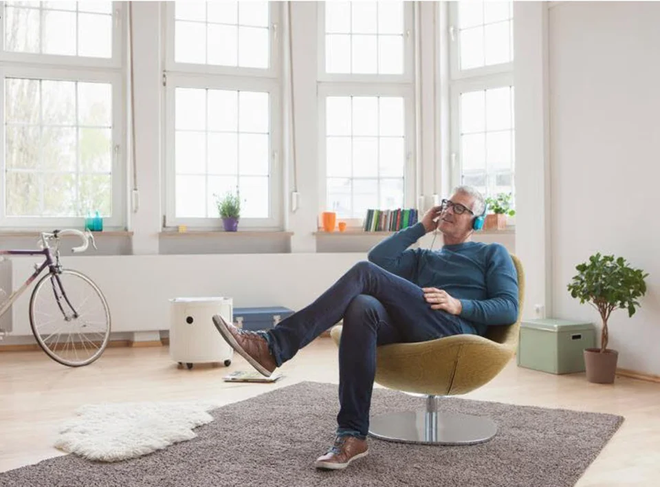 A man sitting listening to music