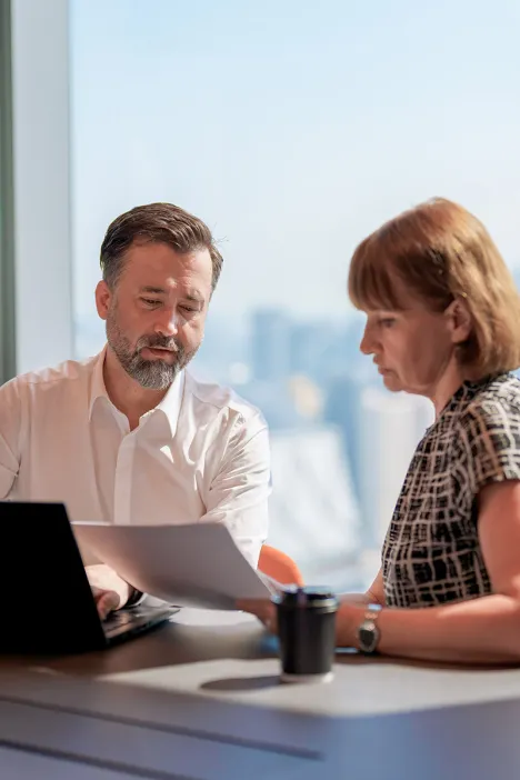 business-partners-discussing-meeting-room-cityscape-skyline-view