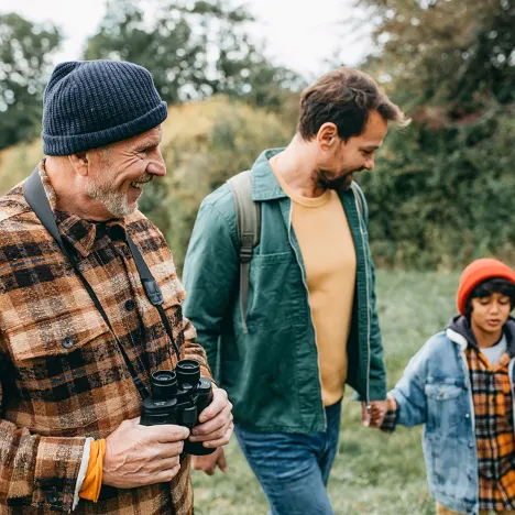 boy-with-father-and-grandfather-walking-in-forest-nature