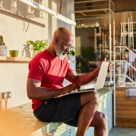 businessman-concentrating-on-work-while-using-laptop-at-home