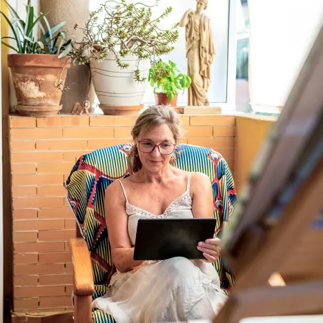 happy-and-confident-woman-consults-her-investments-on-her-tablet