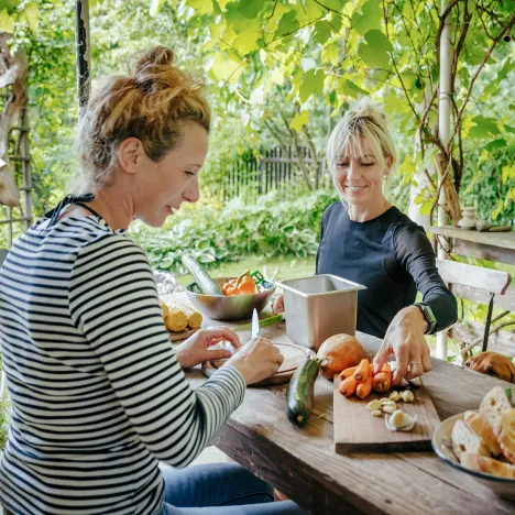 two-women-preparing-vegetables-for-lunch-together