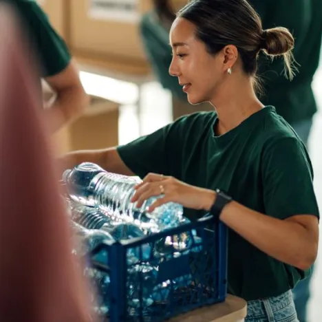 Woman giving water for disaster relief 